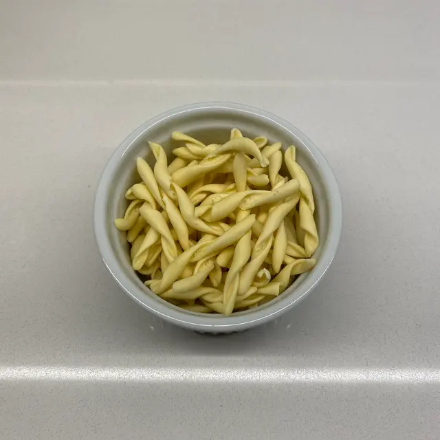 Strozzapreti in a round white ramekin