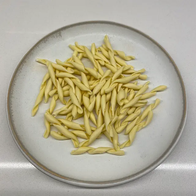 Strozzapreti on a round white plate