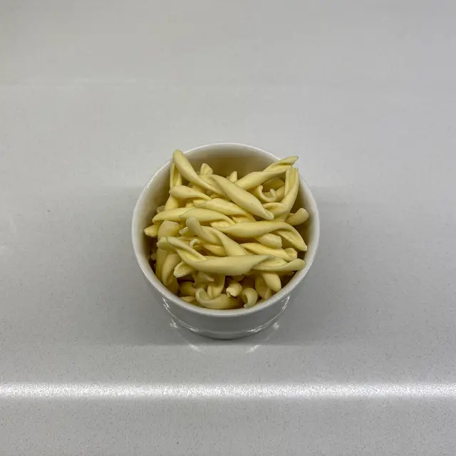 Strozzapreti in a small white bowl