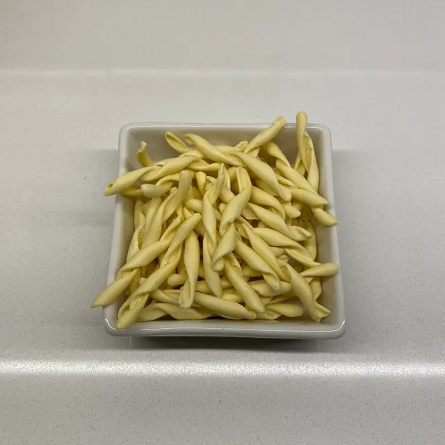 Strozzapreti in a square white glass bowl