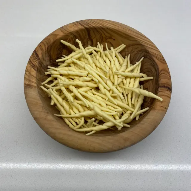 Trofie in a round wooden bowl