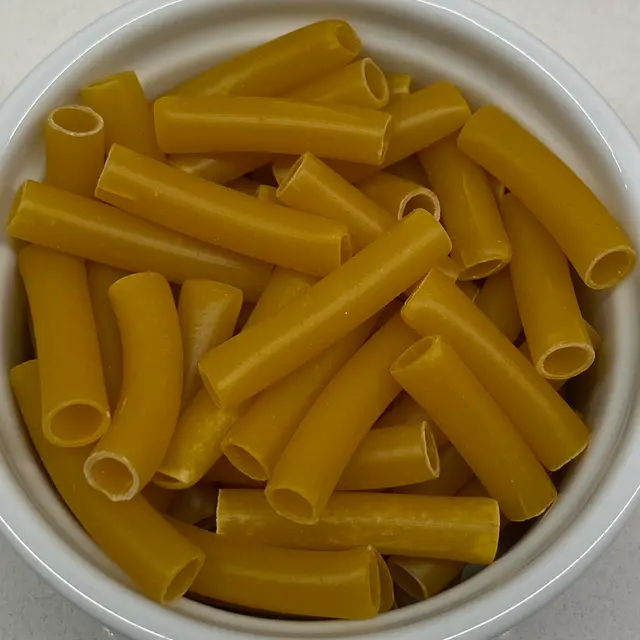 A close up shot of Ziti in a round white ramekin