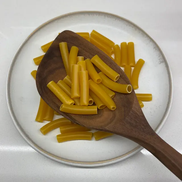 Ziti in a wooden serving spoon