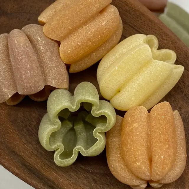 A close up shot of Zucchiette in a wooden serving spoon