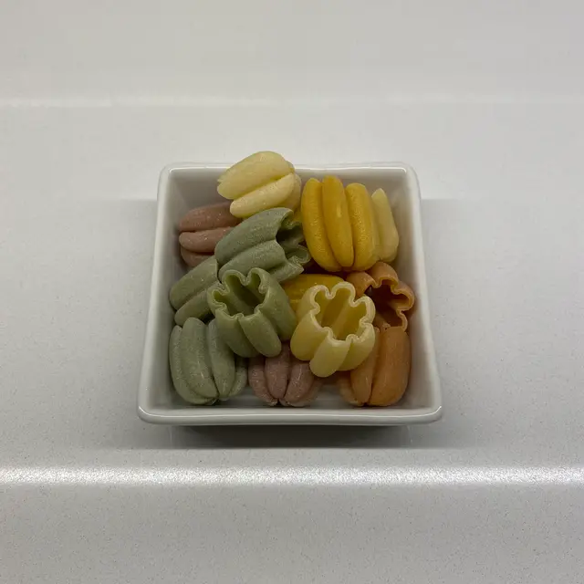 Zucchiette in a square white glass bowl