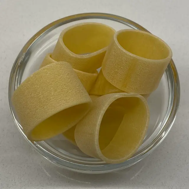 Calamarata in a small round white glass bowl