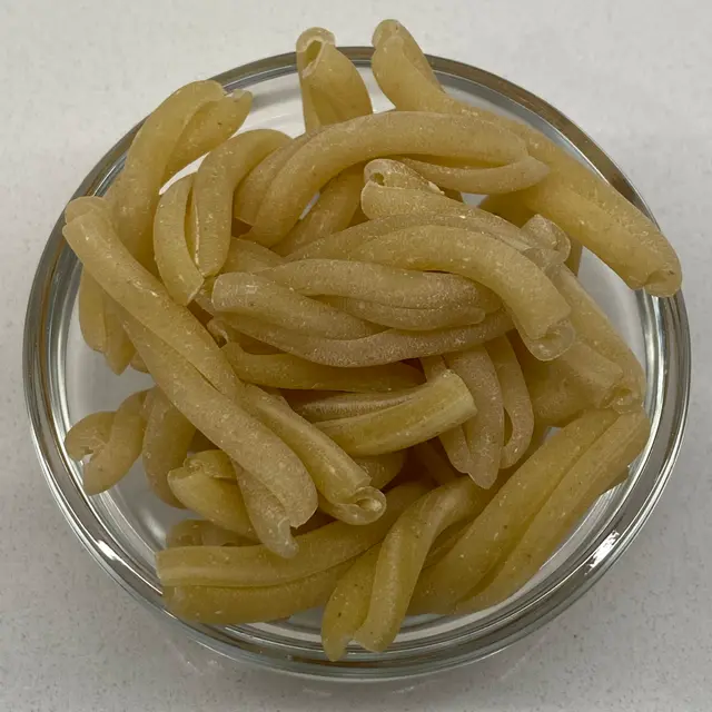A close up shot of Casarecce in a small round white glass bowl