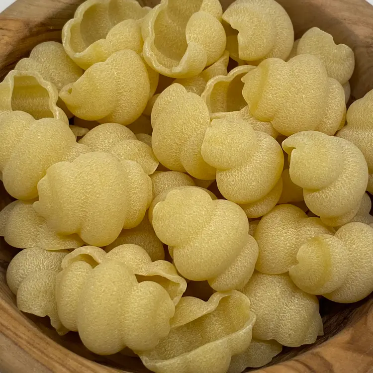 A close up shot of Cestini in a round wooden bowl