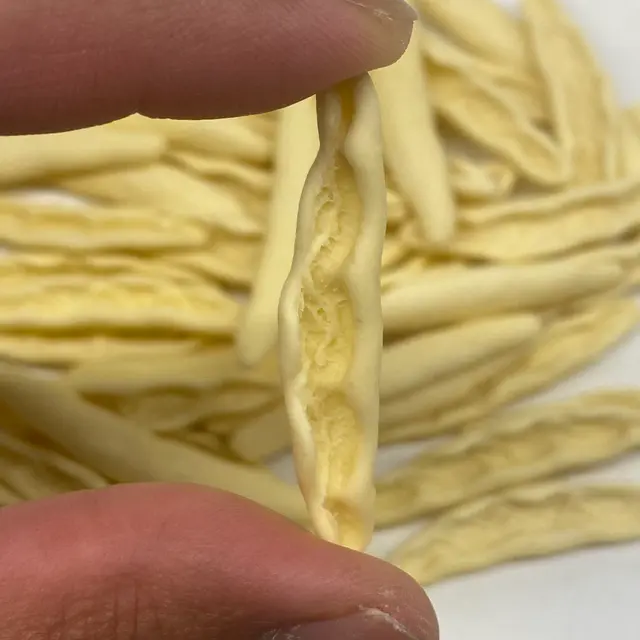 A close up shot of Foglie d’ulivo held between fingers