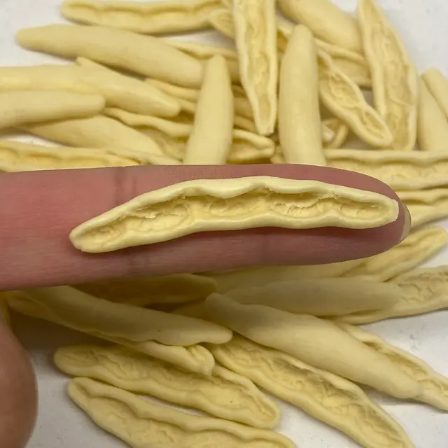 A close up shot of Foglie d’ulivo held between fingers