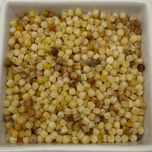 A close up shot of Fregola in a square white glass bowl