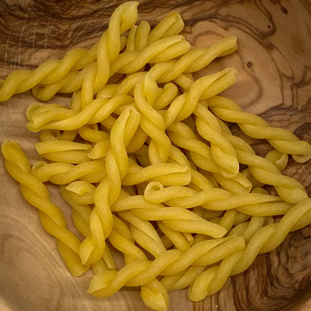 A close up shot of Gemelli in a round wooden bowl