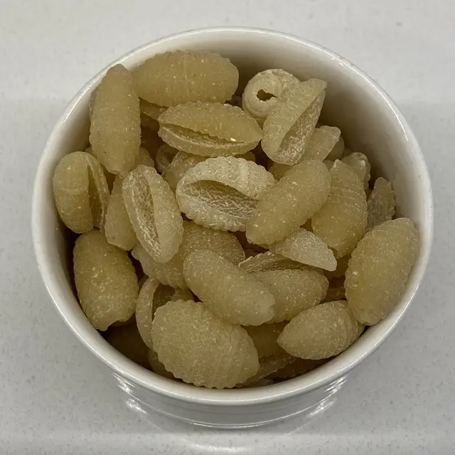 A close up shot of Malloreddus in a small white bowl