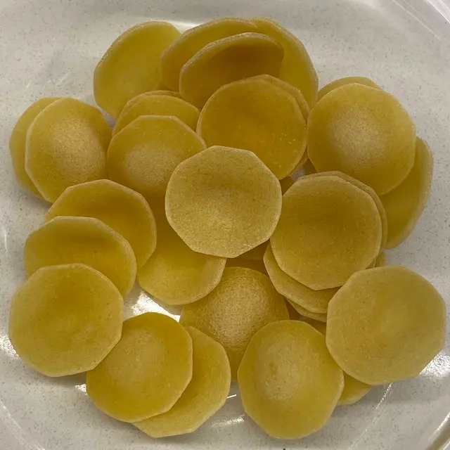 A close up shot of Orecchiette in a clear round glass bowl