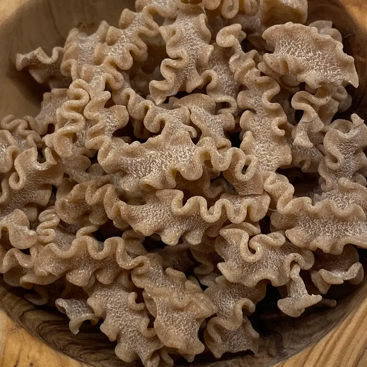 A close up shot of Scarabocchio in a round wooden bowl