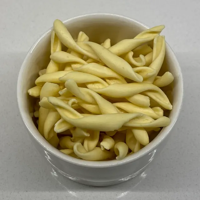 A close up shot of Strozzapreti in a small white bowl