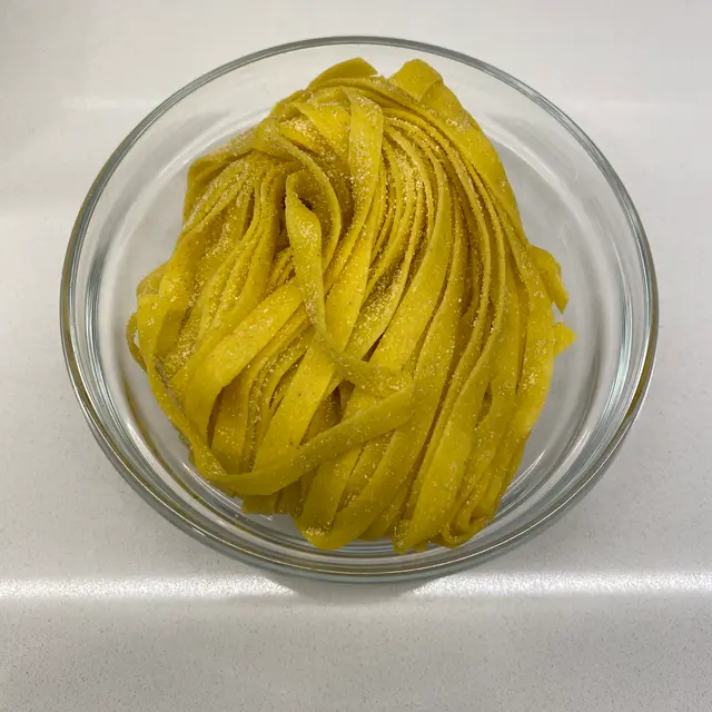 Tagliatelle in a clear round glass bowl