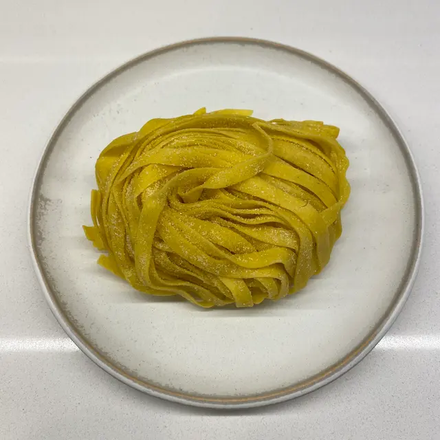 Tagliatelle on a round white plate