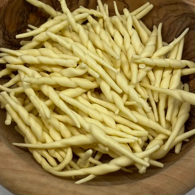 A close up shot of Trofie in a round wooden bowl