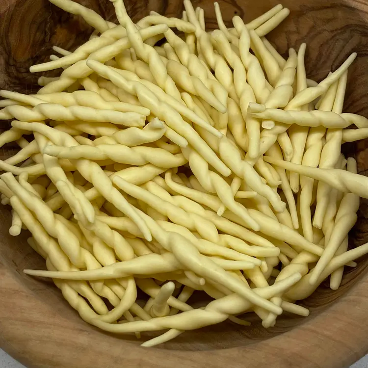 A close up shot of Trofie in a round wooden bowl