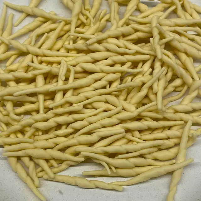 A close up shot of Trofie on a round white plate