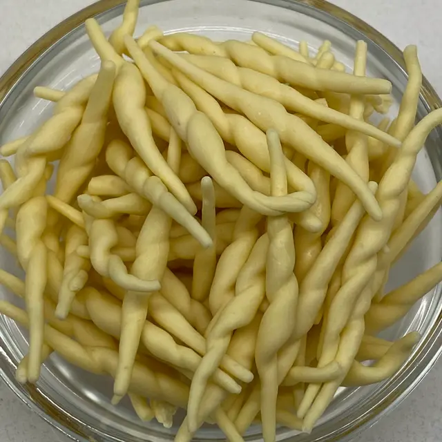 A close up shot of Trofie in a small round white glass bowl