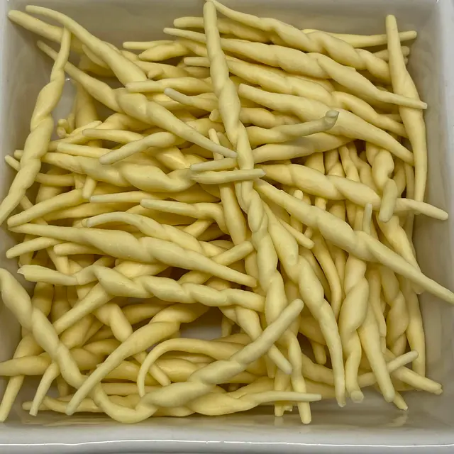 A close up shot of Trofie in a square white glass bowl