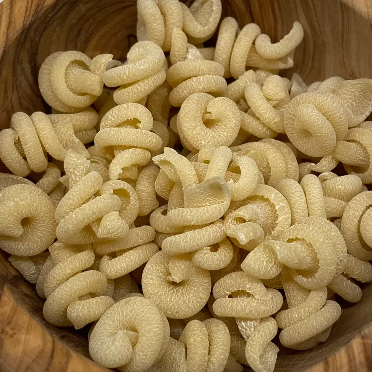A close up shot of Trottole in a round wooden bowl